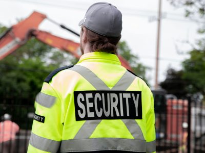 Security guard patrolling the street next to the construction area